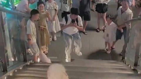 The dog plays skateboard and many people watch
