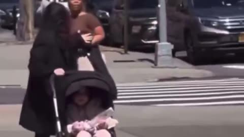 Black woman spits on random baby