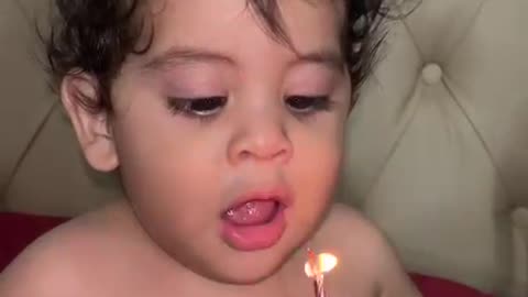 Little Boy Trying His Best to Blow Out Candles