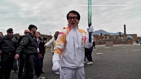 Jackie Chan carries the Olympic Torch through the ruins of Pompeii