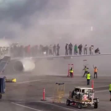 Fire on plane at Denver airport forcing passengers to evacuate onto the wing