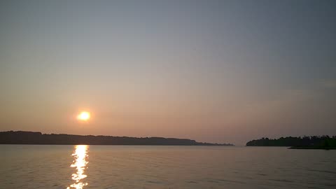 Sun rising over peaceful nature river