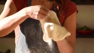 Beautiful woman making pizza