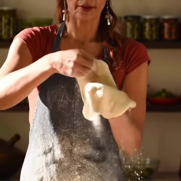 Beautiful woman making pizza