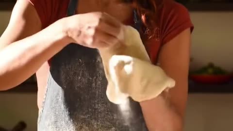 Beautiful woman making pizza