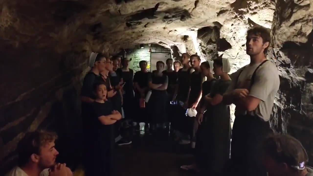 Amish in Western North Carolina, dozens singing hymns in the caves below Chimney Rock.