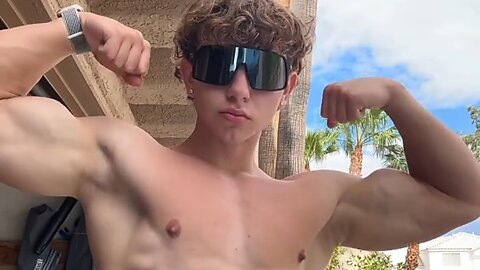 Handsome muscular man showing off his muscles