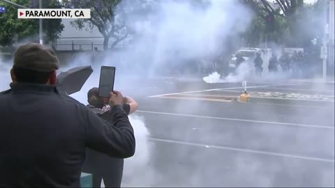 Anti-ICE crowd taunts law enforcement outside a Home Depot in the Los Angeles suburb of Paramount.