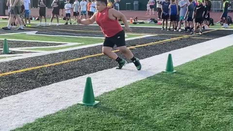 Young Athlete Goes 110% in Football Drill