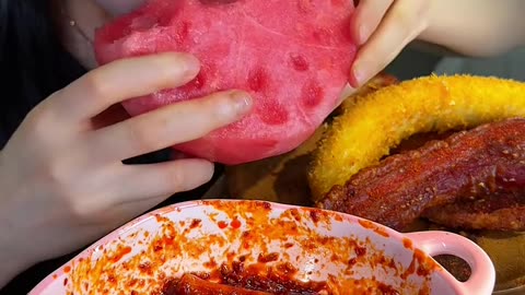 Stir-fried rice cake strips with crispy pork belly and big watermelon are so good