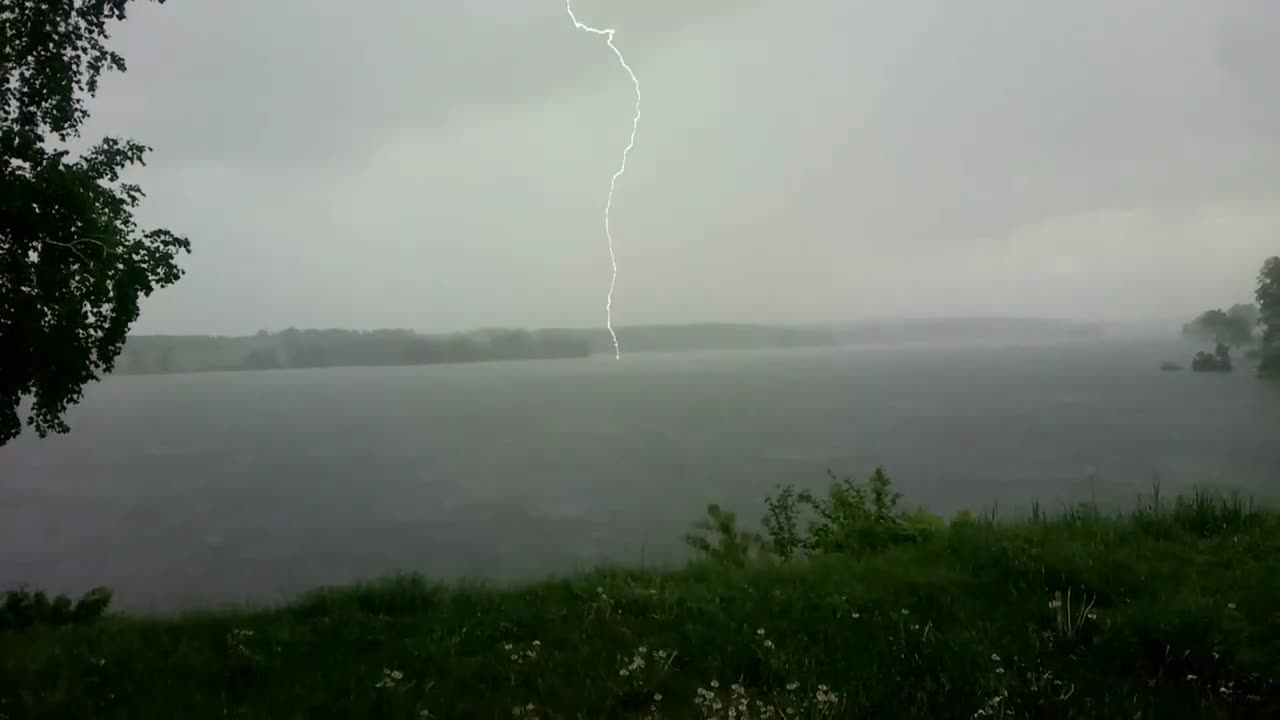 A powerful lightning bolt hits the lake