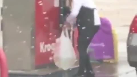Woman dispenses gasoline into hole-filled plastic shopping bag, ties it