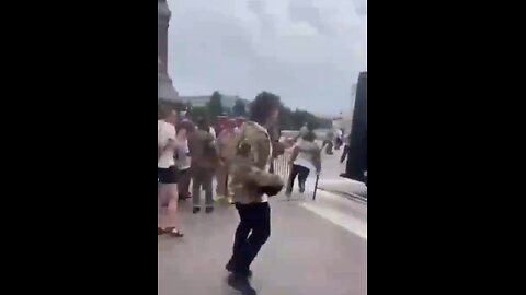 People break through a police barricade and rush the US Capitol