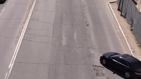 Civilian Fixes Hole in the Road