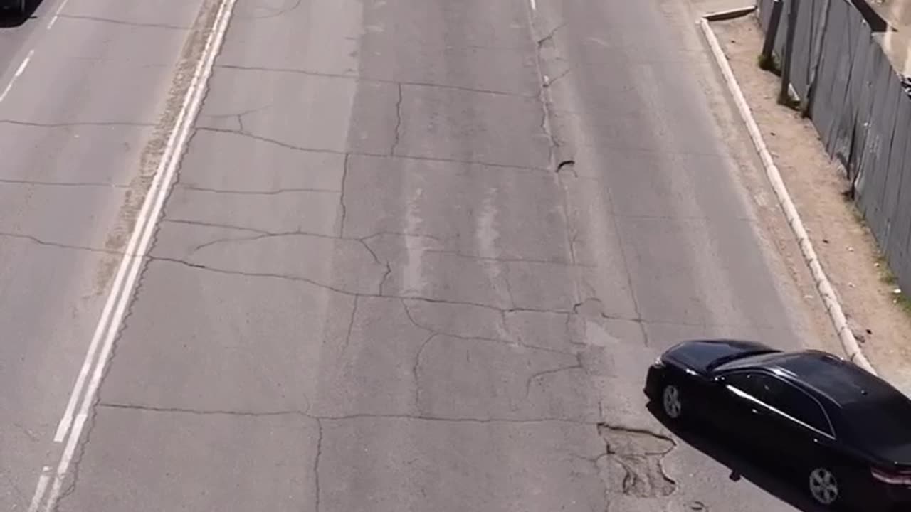 Civilian Fixes Hole in the Road
