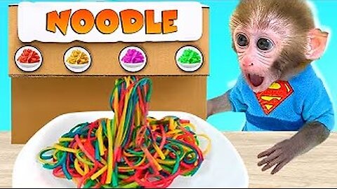 Monkey baby Bon Bon eats colorful pasta and swims with the puppy in the pool