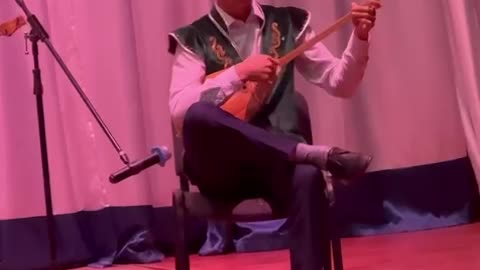 My child playing traditional Kazakh dombra music