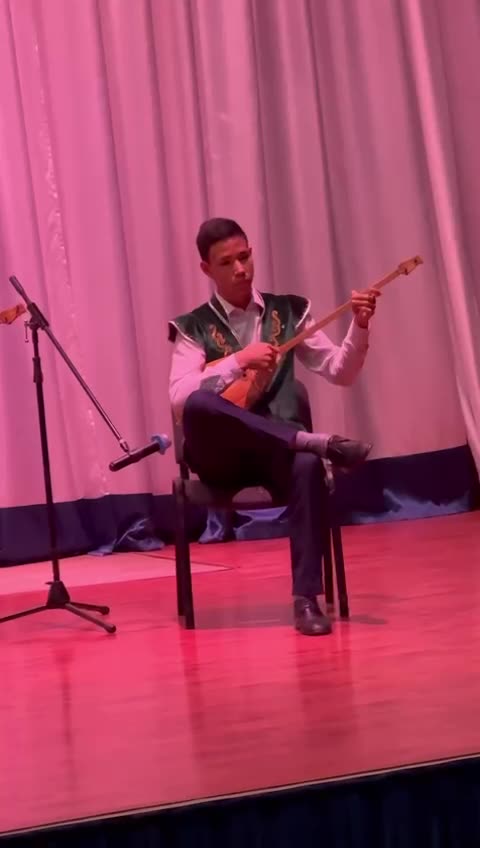 My child playing traditional Kazakh dombra music