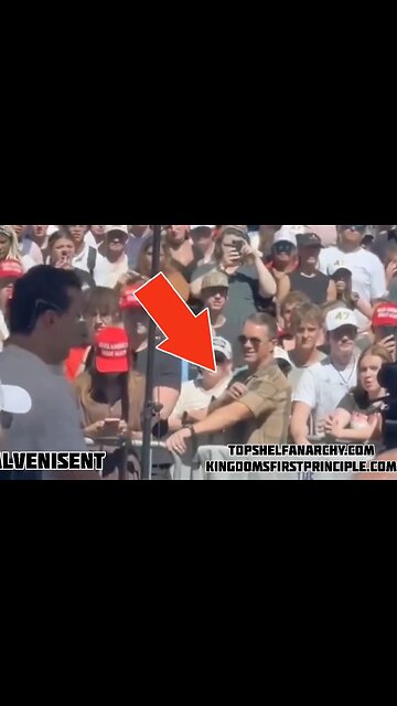 Is this Charlie Kirk's Assassin in the front row using a PALM PISTOL between his fingers?