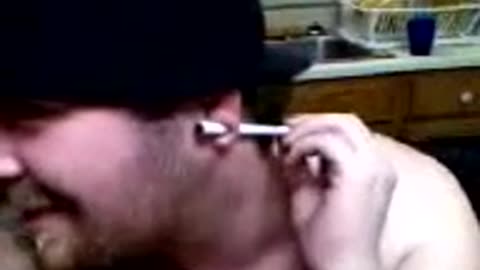 Ron_2007_03_01_Rob pulls a pen out of his gauged ear