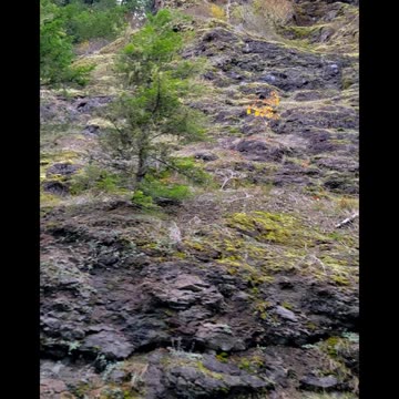 Giants using rocks as doors in the side of mountains