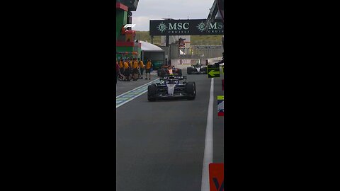 A close one between George and Oscar in the pits