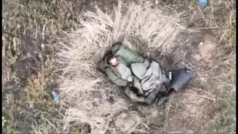 Ukrainian forces using a drone to drop a munition on two Russian servicemen