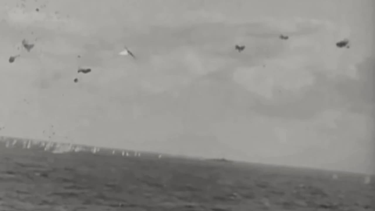Twin-engined Japanese bomber set ablaze by a 5 inch shell from a US warship in 1945