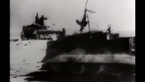 panzerjager rolls past a burning universal carrier