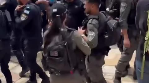 A lone Palestinian confronts a crowd of illegal settlers
