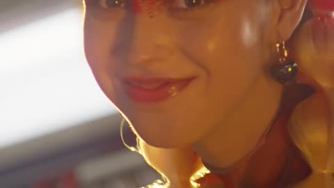 Woman with braided hair and vibrant makeup