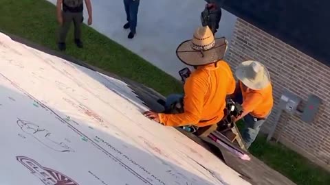 Illegals stay on the roof of a house to try to avoid deportation.