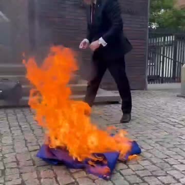 Grzegorz Braun burns an EU (European Union) flag