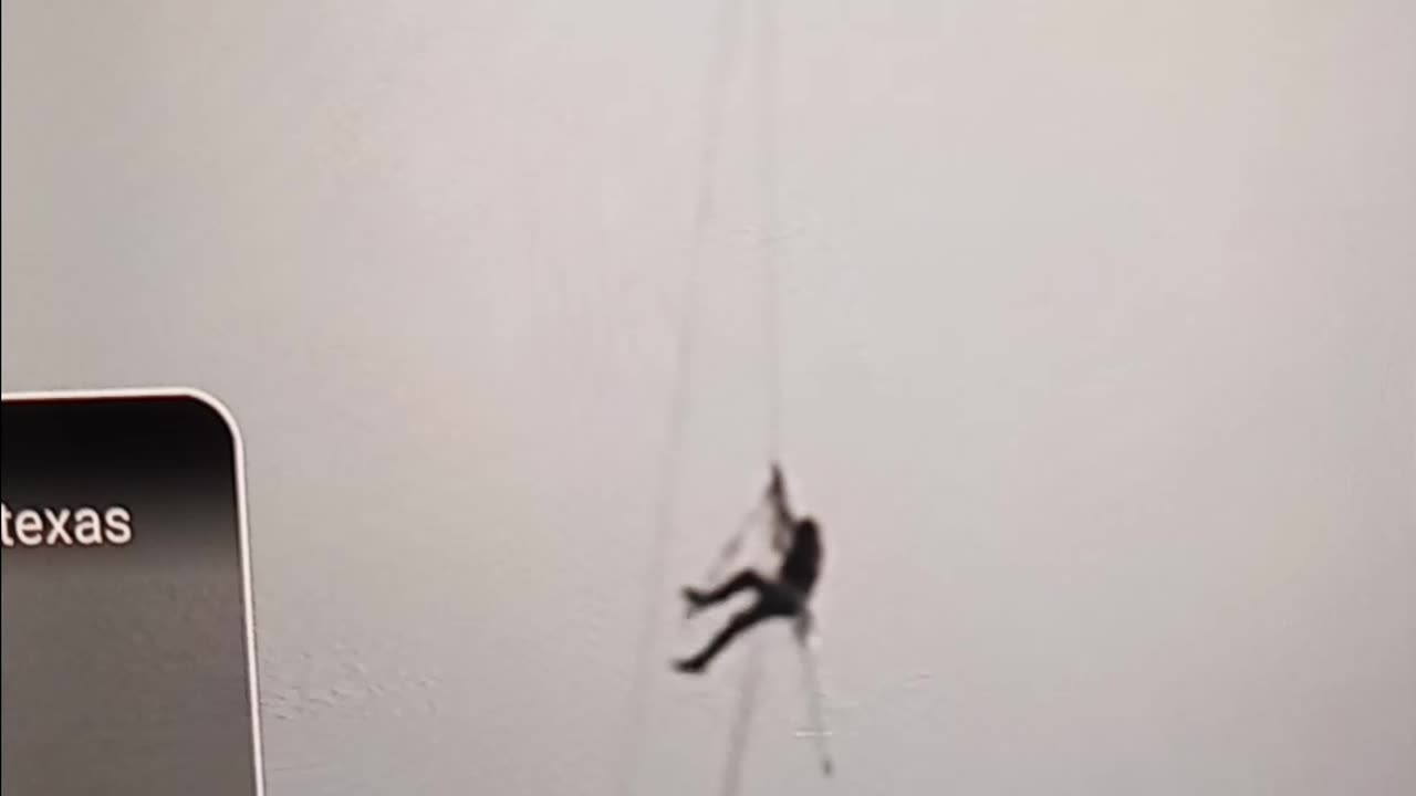Man swings from construction crane in Austin