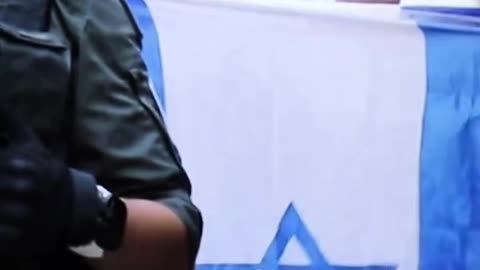 Israeli settlers raise their flag and make provocative gestures toward Palestinians