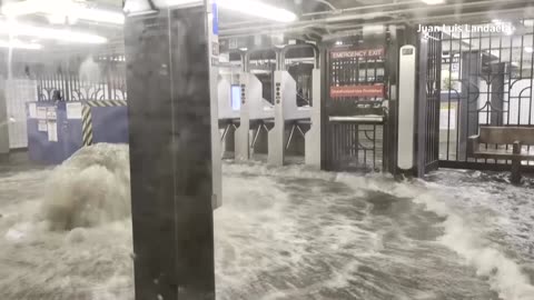 Floodwater gushes into New York subway station during heavy rain