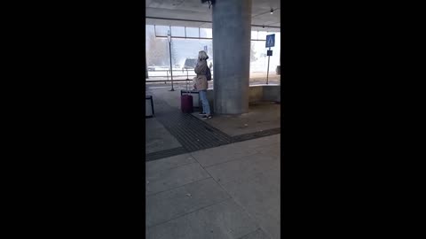 Woman is freezing while waiting for the bus