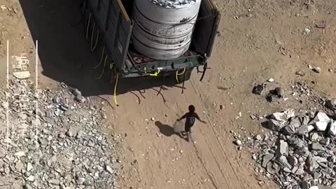 “ A barefoot child runs after an empty water truck in southern Gaza“