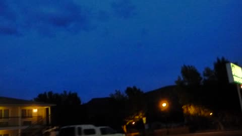 Trying out low light night setting upon clouds, green light, sneezing, and some creepy drunk guy