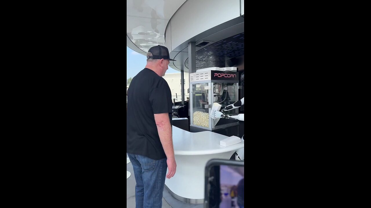 Tesla's Optimus robot is seen serving popcorn at the newly opened Tesla Diner in Hollywood, CA
