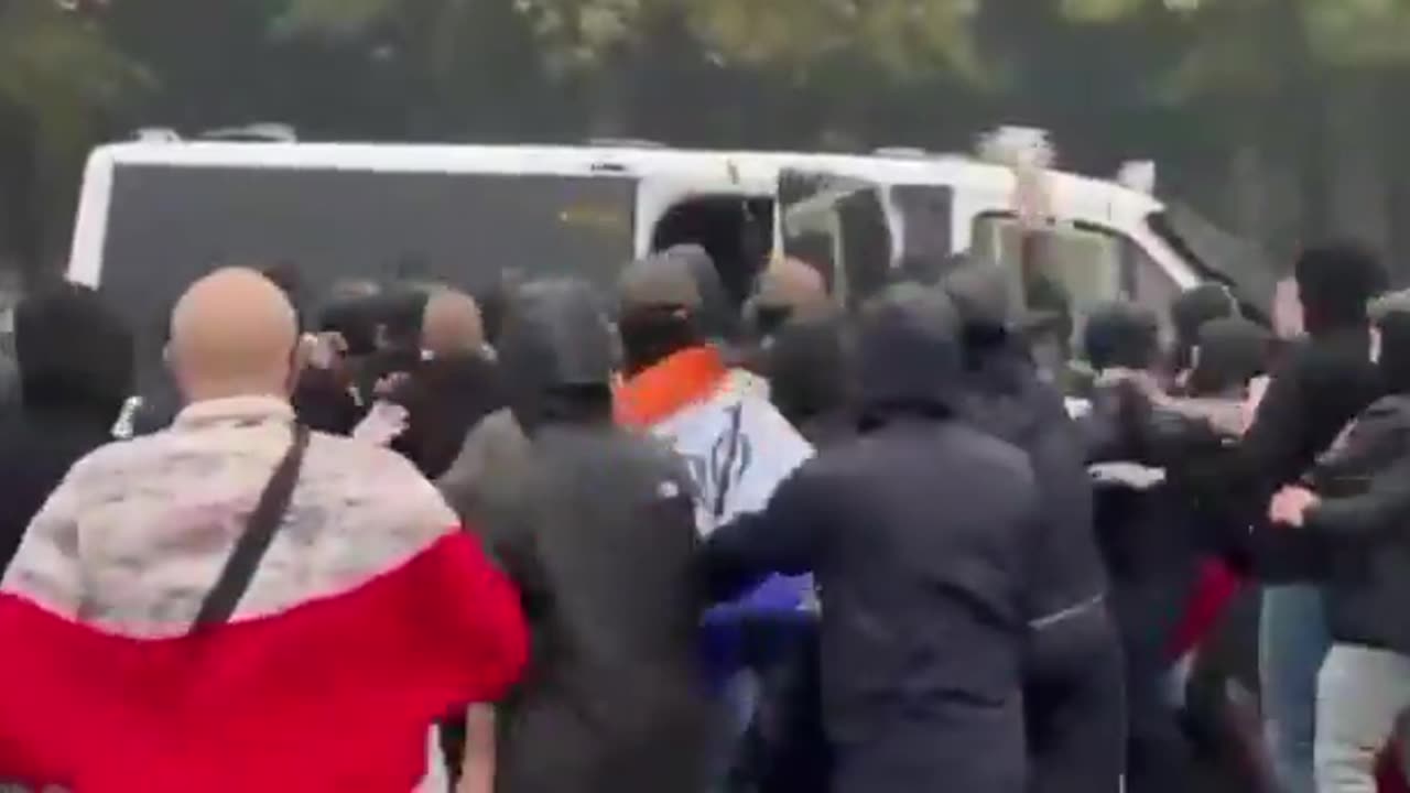 Dutch police are beat into oblivion and forced back into their vehicle.