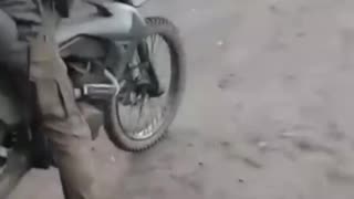 Russian Soldier on Dirtbike Doesn't Even Make It Out of The Driveway Before Crashing