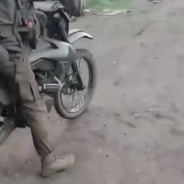 Russian Soldier on Dirtbike Doesn't Even Make It Out of The Driveway Before Crashing