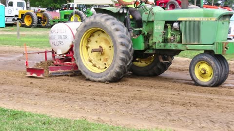 John deer tractor smoothing out some dirt