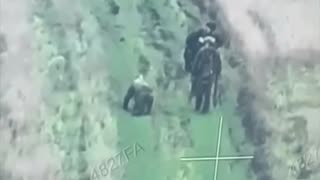 🤯 Russian soldiers calmly walk past their wounded comrade, who is kneeling by in search of help.