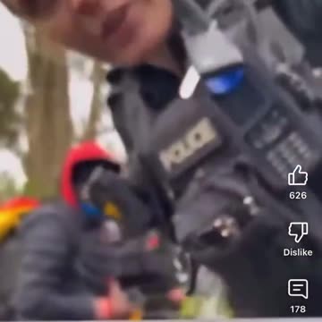 An African is caught on CCTV hiding in bushes outside a school.