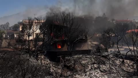Helicopters drop water as wildfires burn in Greece
