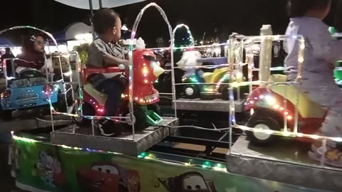 "Children's Joy on the Odong-Odong at Night"