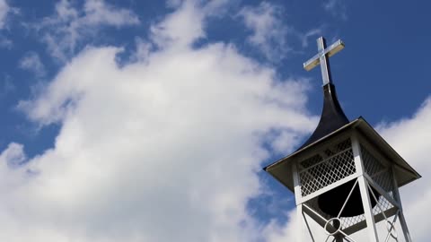 Guitar music with sounds of birds and bell tower.