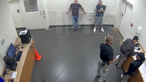 Police officers stop fellow officer punching handcuffed woman during arrest